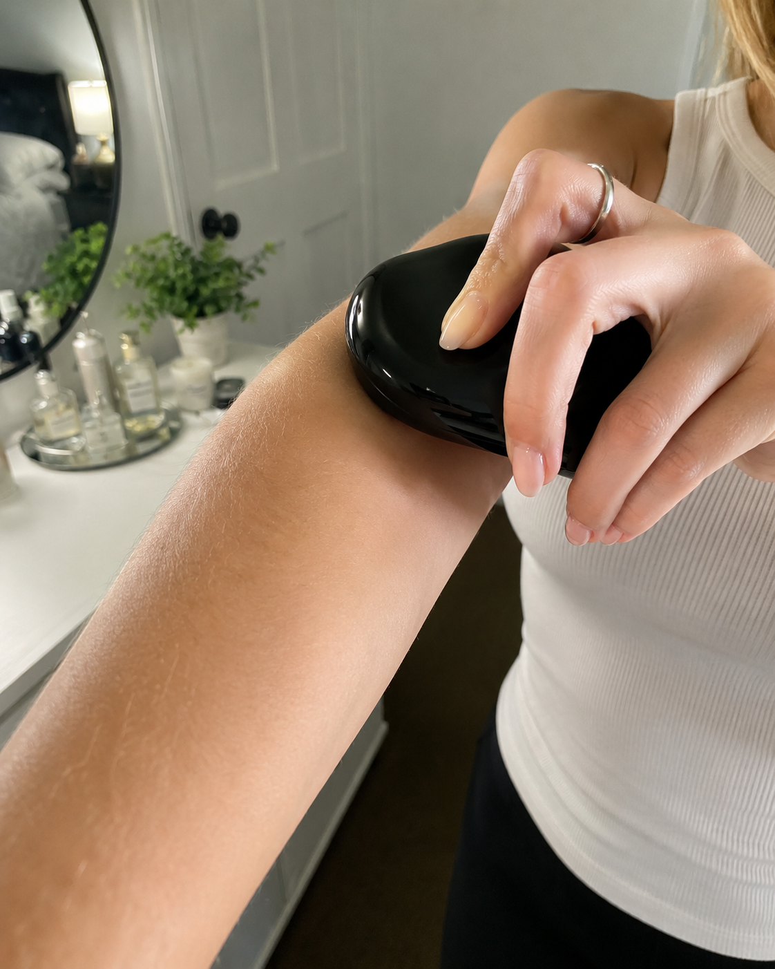 American woman comparing fine arm hair and thicker leg hair at home